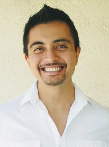 Miguel Buenaflor Smiling in a White Shirt