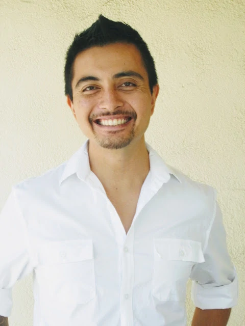 Miguel Buenaflor Smiling in a White Shirt